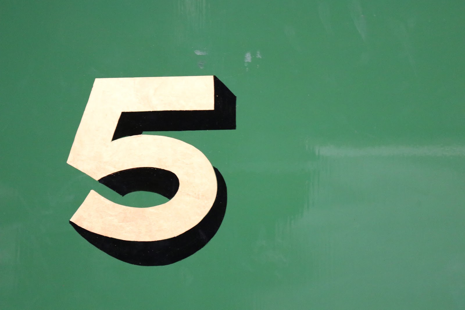 A number five appears on a green background