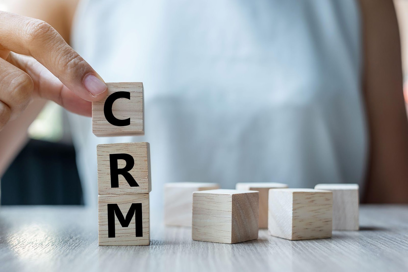 building blocks are stacked to spell "CRM" 